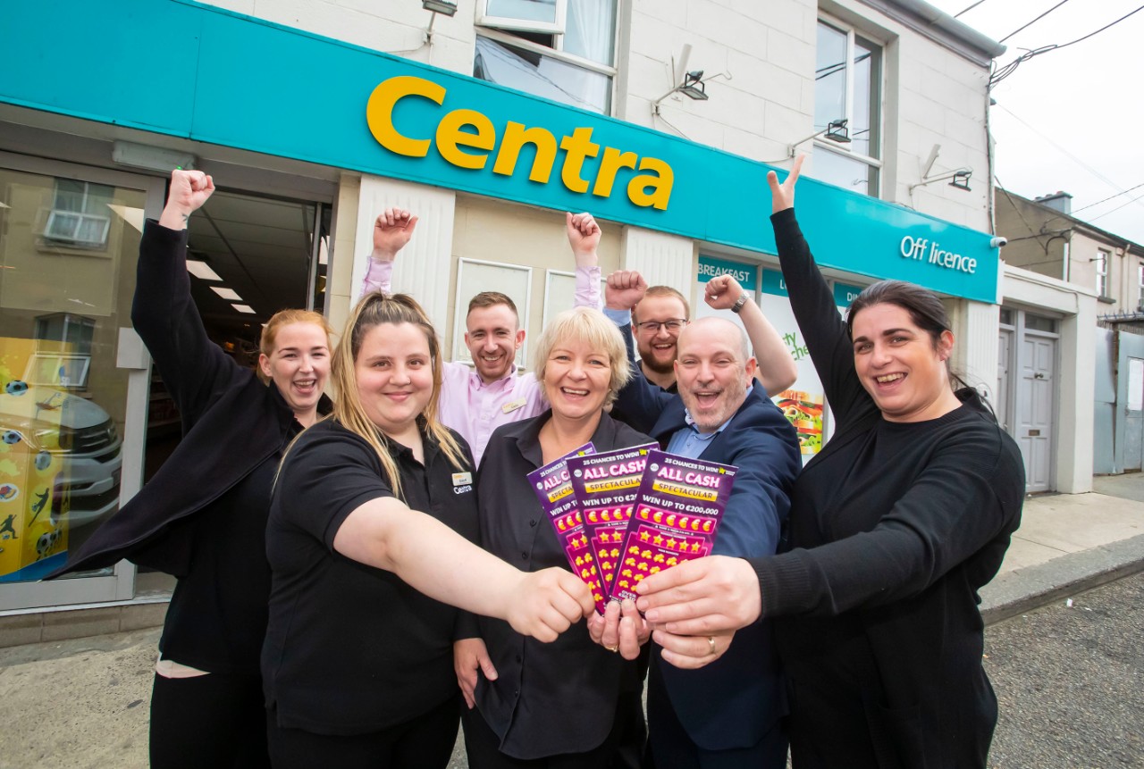 NO REPRO FEE: 24th July 2023. Staff at Centra Enniscorthy, Templeshannon, Co. Wexford celebrate after they sold a top prize of €200,000 on an All Cash Spectacular scratch card. Pictured with Michael Molloy of the National Lottery are staff from Centra, Sarah Louise Kearney, Claudie Quirke, Catherine Ennis, Patsy O’Toole, Eddie Murphy and Cathal O’Rourke. Photograph: Patrick Browne / Mac Innes Photography